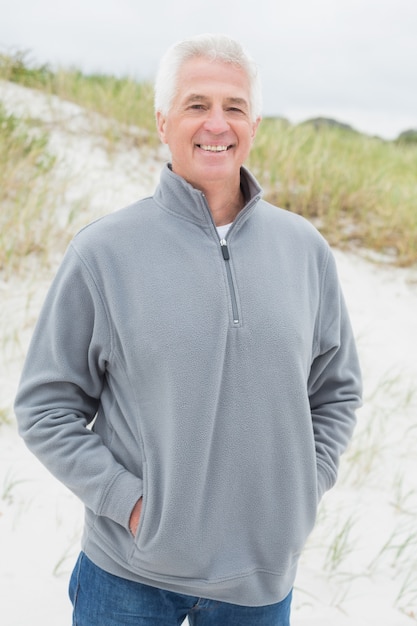portrait of smiling casual senior man at beach