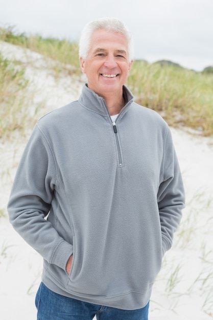 Portrait of smiling casual senior man at beach