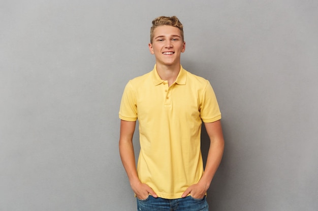 Portrait of a smiling casual teenage boy standing