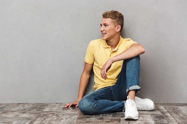 Portrait of a smiling casual teenage boy with sitting