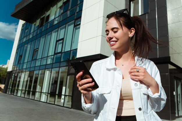 Portrait of smiling caucasian woman with white teeth chatting on phone