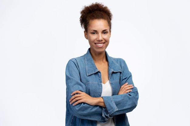 Portrait of smiling confident African American business woman with arms crossed looking at camera