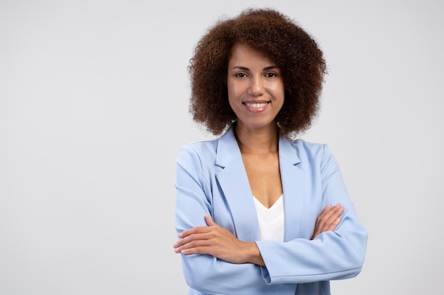 Portrait of smiling confident African American manager with arms crossed isolated on background