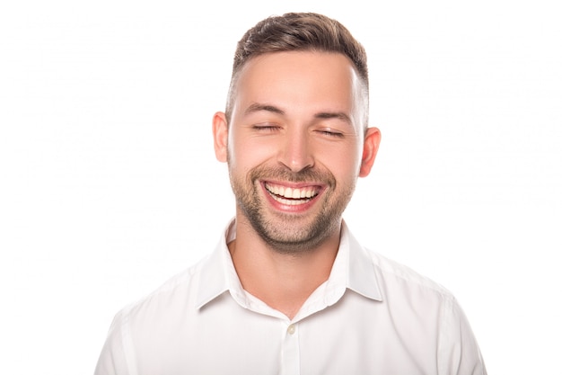 portrait of smiling confident businessman with closed eyes in white shirt isolated on white