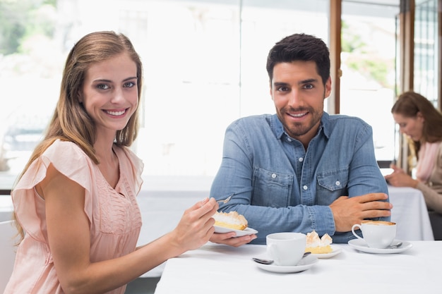 Portrait of a smiling couple at coffee shop