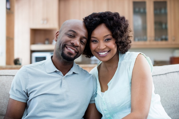 Portrait of smiling couple in living room