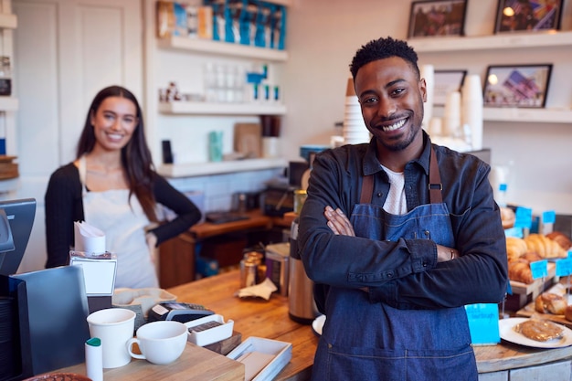 Photo portrait of smiling couple running coffee shop together standing behind counter