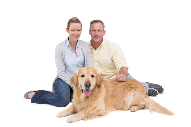 Portrait of smiling couple sitting together with their dog