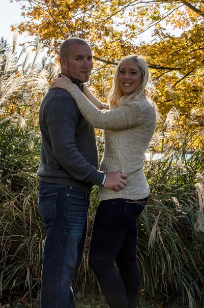 Portrait of smiling couple standing on field