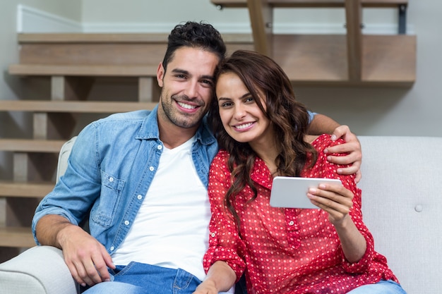 Portrait of smiling couple using smartphone 