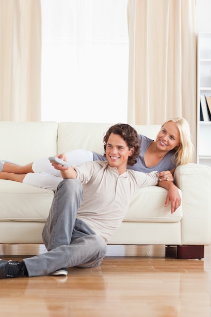 Portrait of a smiling couple watching TV