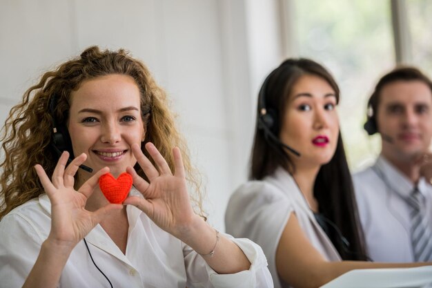 Photo portrait of smiling customer representative showing heart shape