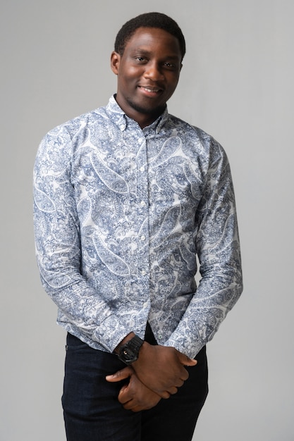 Portrait of smiling dark skinned young man isolated on white 