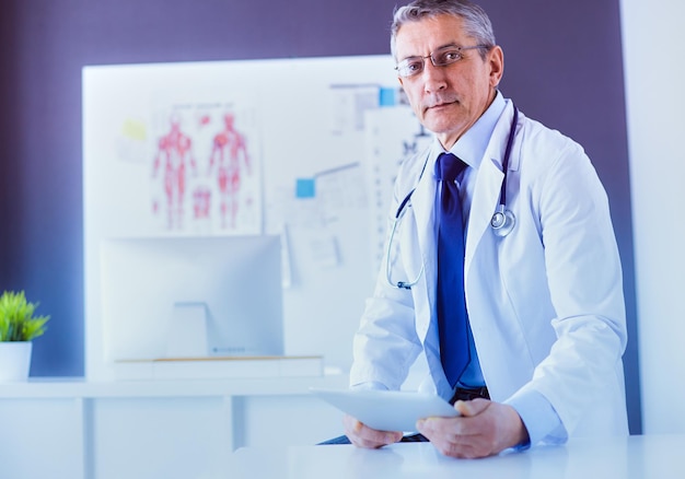 Portrait of a smiling doctor in his bright office