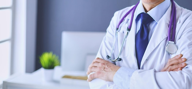 Portrait of a smiling doctor in his bright office