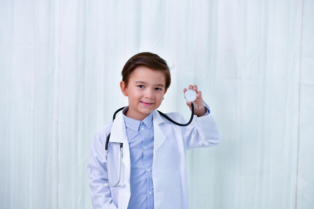 Portrait of smiling doctor holding stethoscope in hospital