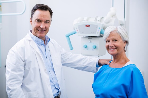 Portrait of smiling doctor and senior woman during medical check-up