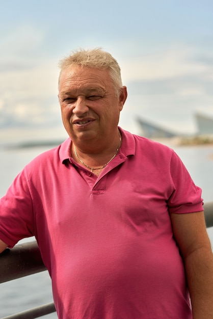 Portrait of a smiling elderly man with short gray hair