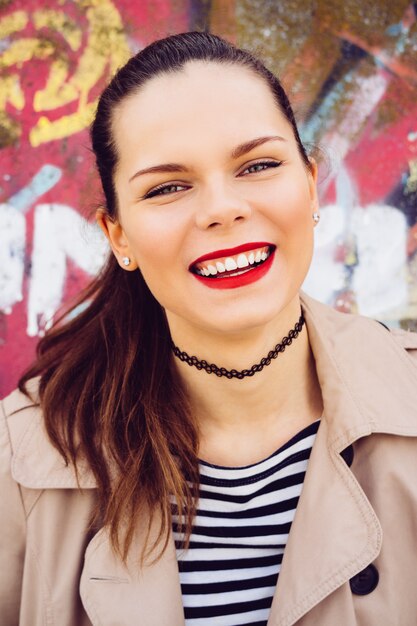 Portrait of a smiling emotional girl on a bright background