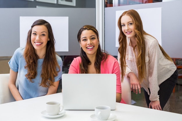 Portrait of smiling executives in conference room