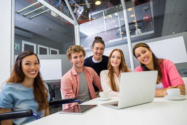 Portrait of smiling executives in conference room