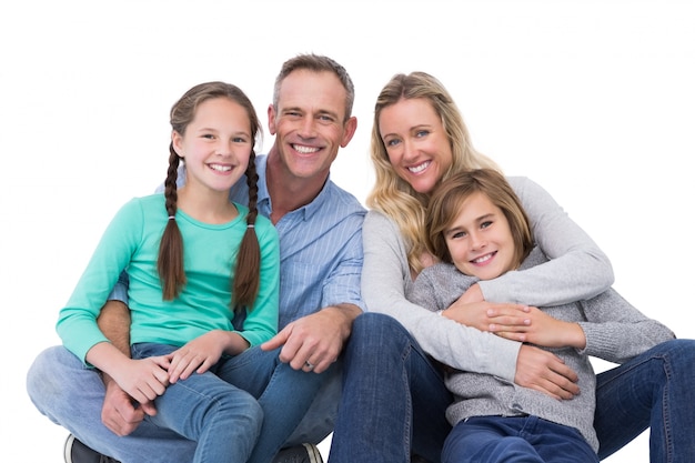 Portrait of a smiling family sitting on the floor