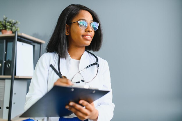 Portrait Of Smiling Female Doctor Wearing White Coat With Stethoscope In Hospital Office