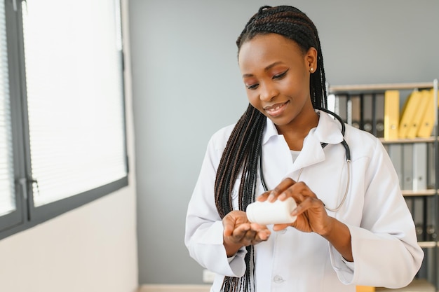 Portrait Of Smiling Female Doctor Wearing White Coat With Stethoscope In Hospital Office