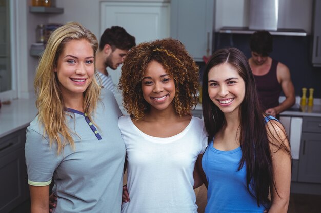 Portrait of smiling female friends with arm around 