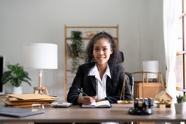 Portrait smiling female lawyer sitting at workplace in office