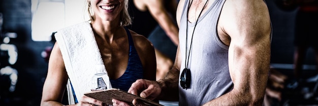 Photo portrait of smiling fitness instructor with woman in gym