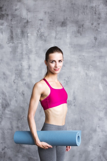 Portrait smiling fitness woman holding yoga