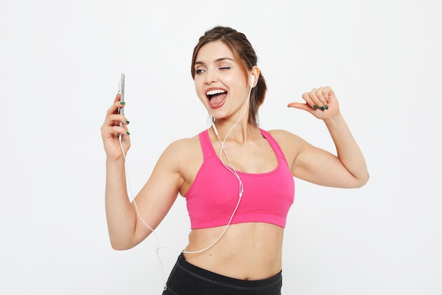 Portrait of a smiling fitness woman with smartphone Selfie time