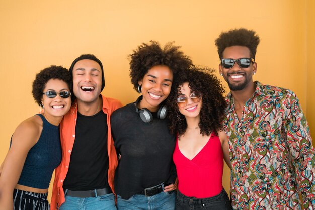 Photo portrait of smiling friends against orange background