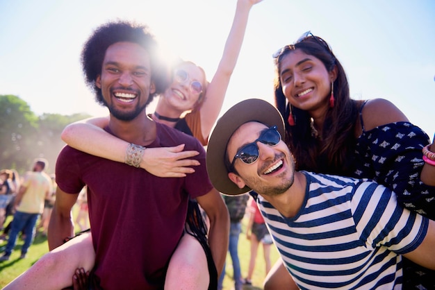 portrait of smiling friends against sky
