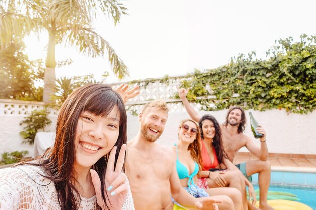 Portrait of smiling friends enjoying at swimming pool