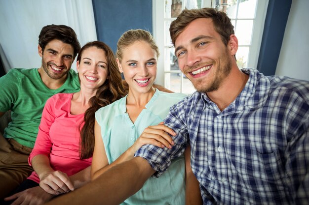 Portrait of smiling friends at home