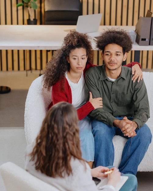 Photo portrait of smiling friends sitting on bed at home