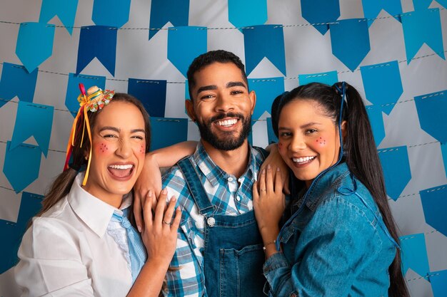 Portrait of smiling friends standing against sky