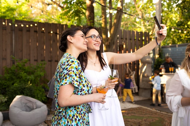 Portrait of smiling friends standing against trees