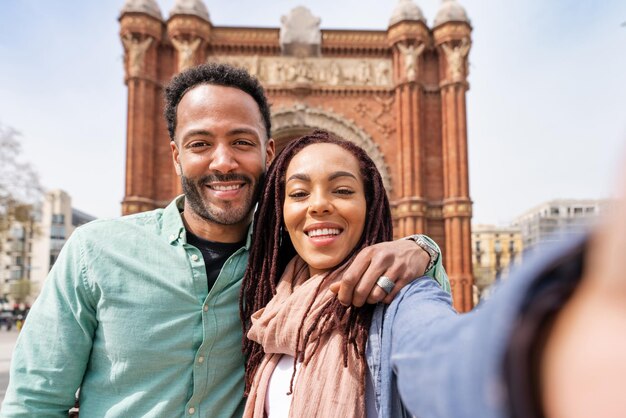 Portrait of smiling friends standing in city