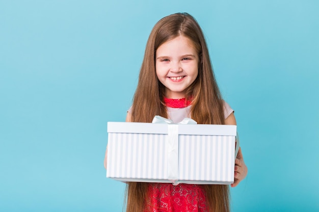 Portrait of smiling girl against blue background