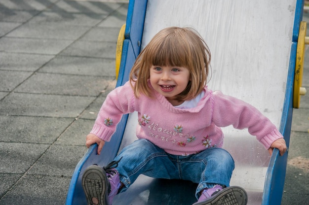 portrait of smiling girl playing on playground