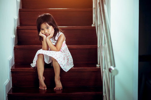 Portrait of smiling girl sitting in corridor