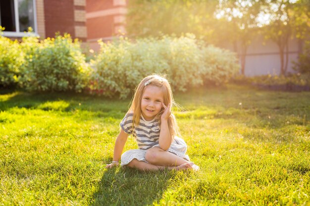 Portrait of a smiling girl sitting on grass