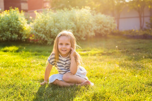 Portrait of smiling girl sitting on grass