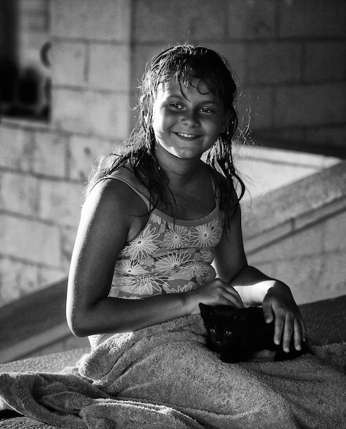 portrait of smiling girl sitting with kitten