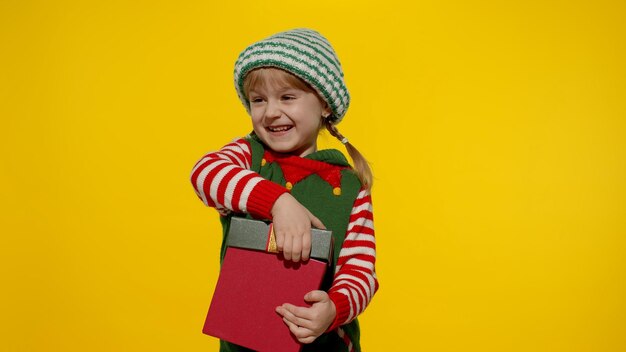 Portrait of smiling girl standing against yellow background