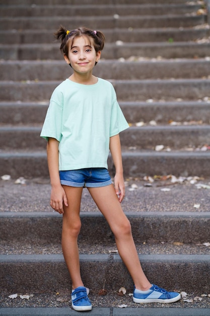 Portrait of smiling girl standing on staircase