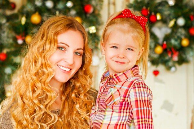 Photo portrait of smiling girl with christmas tree